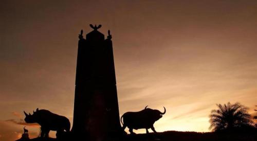 a group of animals standing next to a tower at Baan Hmon-Oon in Chiang Mai