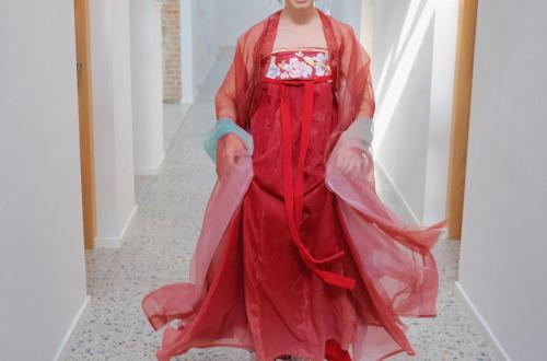 a model walks the runway in a red dress at YiXi Designer Hotel - Xi'an Bell Tower & Ming City Wall & T'ang Dynasty Ever-Bright City in Xi'an