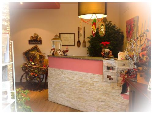 a counter in a restaurant with a brick wall at Florivana Boutique Hotel in San Pietro in Cariano