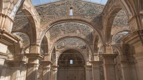 a large building with arches and a brick wall at Hotel & Spa Can Josep in Bot