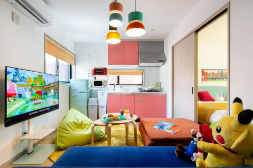 a living room with a tv and a kitchen at M&P Osaka Hotel in Osaka