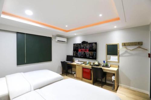 a bedroom with a bed and a desk with a chalkboard at Hotel Primo Daejeon in Daejeon