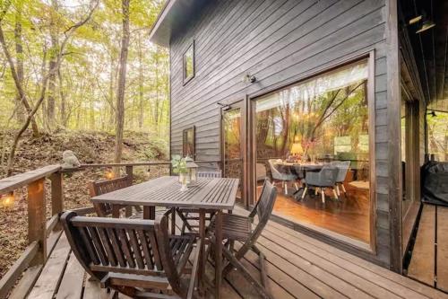 a wooden deck with a table and chairs on it at Nasu Country Cottage in Nasu-yumoto