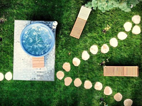 an overhead view of a garden with a swimming pool and wood slices at Chata Leśna Polana in Kurzętnik