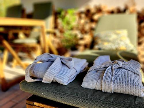 a pair of mittens sitting on a table with a chair at Chata Leśna Polana in Kurzętnik