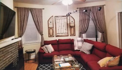 a red couch in a living room with a fireplace at Mt Washington #1 on Grandview at Gazebo Park in Pittsburgh