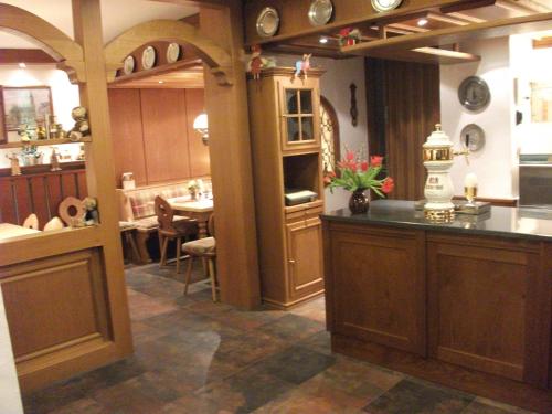 a kitchen with a sink and a table in a room at Hotel Rossner in Münchberg