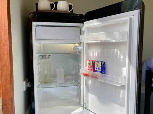 a refrigerator with its door open in a room at Casa Azul - Off-grid Hideaway Agnes Water 1770 in Agnes Water