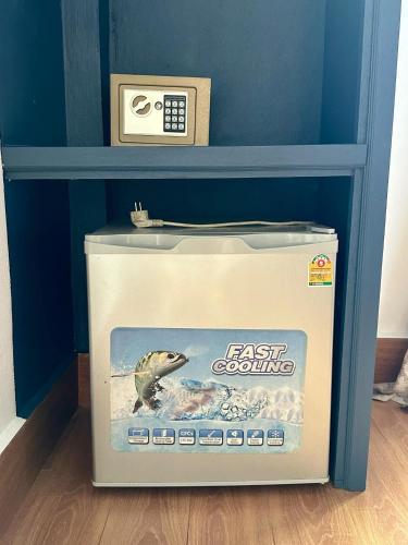 a fish counting box in a shelf with a clock at Zen NamKhan Riverside in Luang Prabang
