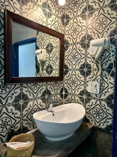 a bathroom with a sink and a mirror at Zen NamKhan Riverside in Luang Prabang
