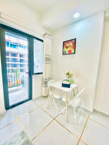 a dining room with a table and a window at SOHO Suites - Saigon Central, 5-Min-To-Bui Vien Street in Ho Chi Minh City