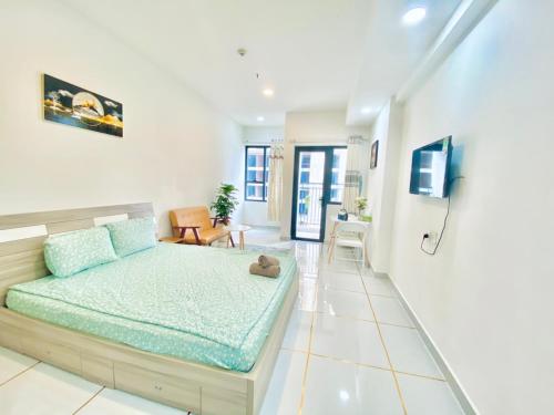 a bedroom with a bed and a living room at SOHO Suites - Saigon Central, 5-Min-To-Bui Vien Street in Ho Chi Minh City