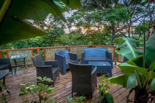 a deck with chairs and a table on it at Easter Island Ecolodge in Hanga Roa