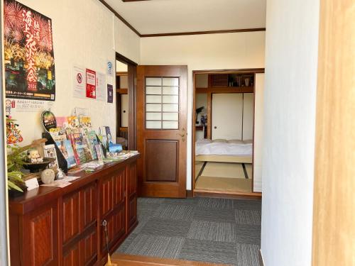 a hallway with a room with a bed in it at Marina Bay Atami in Atami