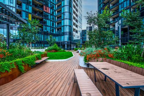 a courtyard in a building with benches and plants at Lakeside Luxe, Free parking, AIS, Spa, Gym, Sauna and Pool in Belconnen