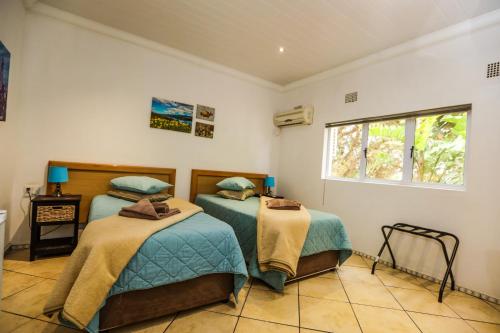 Ένα ή περισσότερα κρεβάτια σε δωμάτιο στο Namaqua Lodge