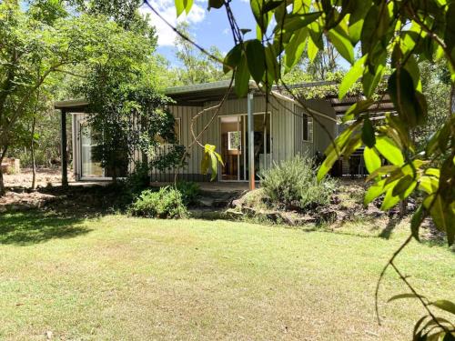 a small green house with a yard at Casa Verde Off-grid hideaway Agnes Water 1770 in Agnes Water