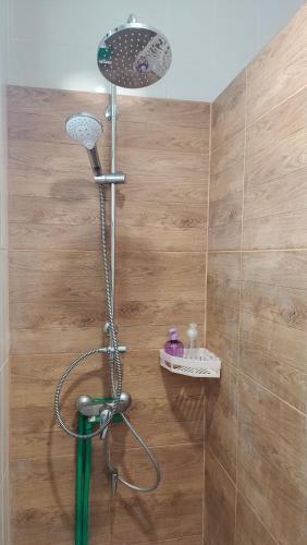 a shower with a shower head in a bathroom at Na Na Doo Homestay in Chiang Rai