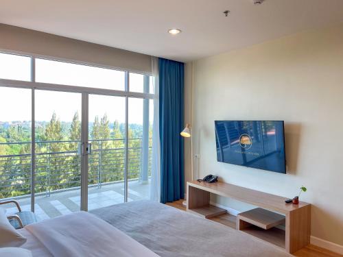 a bedroom with a bed and a large window at The Kaset, Hua Hin in Hua Hin