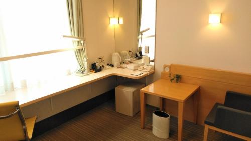 a bathroom with a sink and a mirror at Smile Hotel Matsuyama in Matsuyama