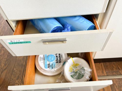 a drawer in a cabinet filled with medicines at Marina Bay Atami in Atami