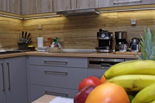 a kitchen with a bunch of fruit on a table at VENUS GUESTHOUSE in Portariá