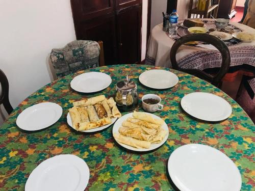 a table with plates of food on it at No 06 Veediya Bandara Lane Bahirawakanda in Kandy