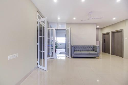 a living room with a blue couch in a building at Super Collection O ISBT in Guwahati