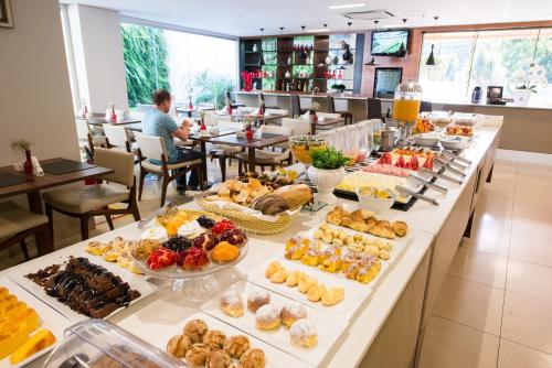 a buffet line with many different types of food at SAN MARINO SUITES HOTEL By NOBILE in Goiânia