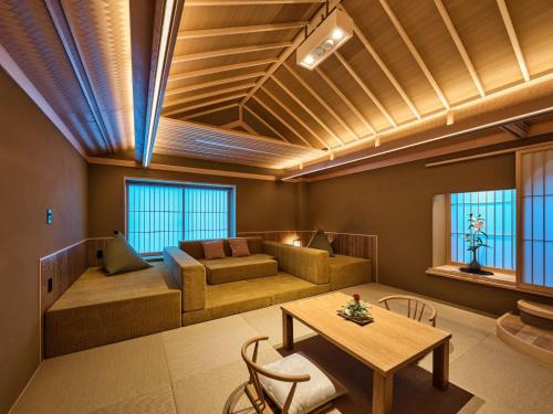 a living room with a couch and a table at Hotel New Wakasa in Nara