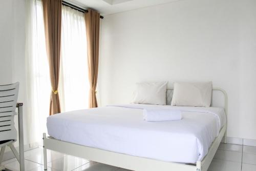 Giường trong phòng chung tại New and Luxury Studio at Casa De Parco Apartment By Travelio
