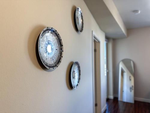 four plates on the wall of a hallway at Modern Comfort in LA Free Parking&10 Min To Cedars in Los Angeles
