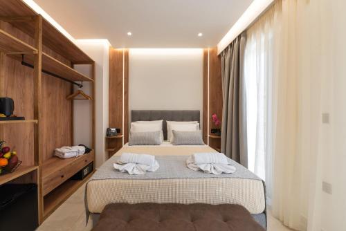 a bedroom with two beds with towels on them at The Wine Hotel in Rhodes Town