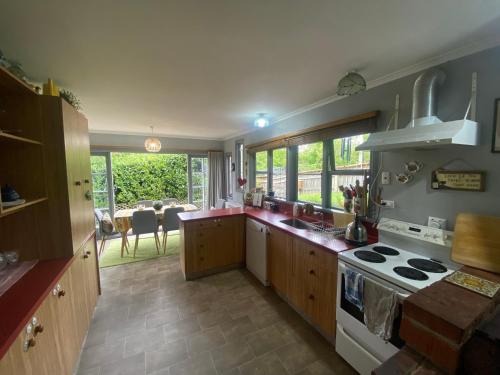 a kitchen with a sink and a stove top oven at Cherry Tree Cottage in Lawrence
