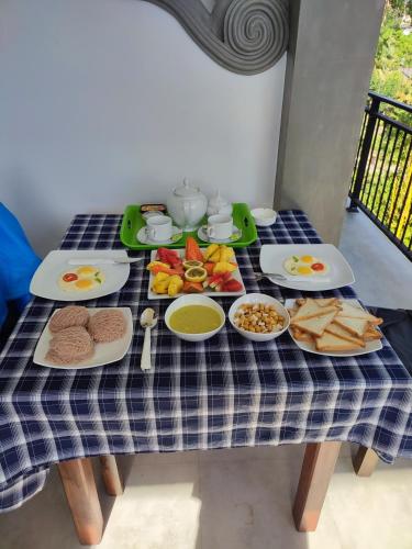 a blue and white checked table with food on it at Green nature in Mirissa