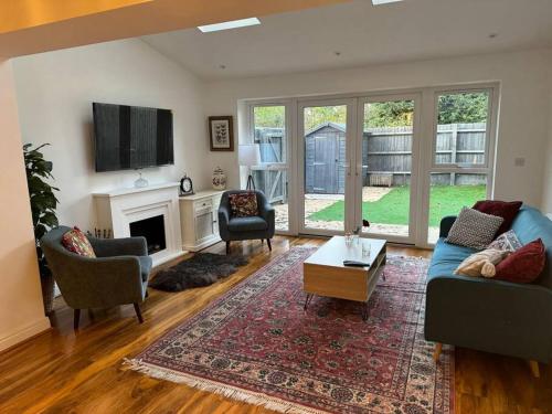 a living room with a blue couch and a fireplace at Windsor and slough in Slough