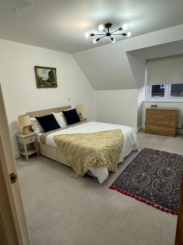 a bedroom with a bed and a ceiling fan at Windsor and slough in Slough