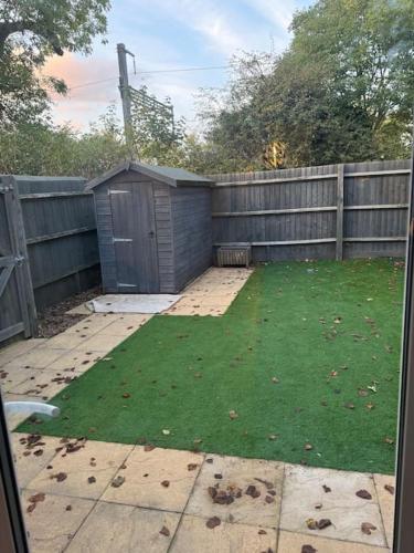 a backyard with a fence and a yard withgrass at Windsor and slough in Slough