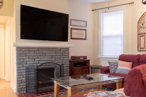 a living room with a fireplace with a flat screen tv at Mt Washington #1 on Grandview at Gazebo Park in Pittsburgh