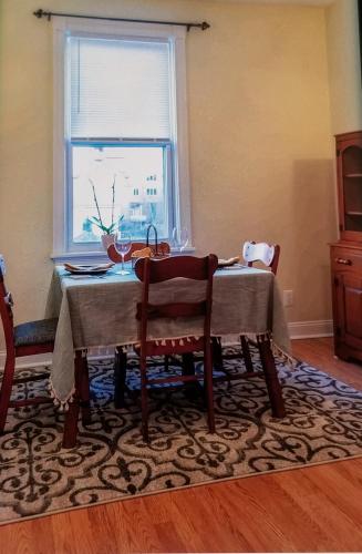 a dining room table with two chairs and a window at Mt Washington #1 on Grandview at Gazebo Park in Pittsburgh