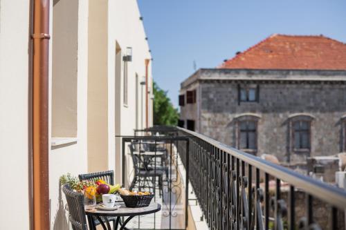 a balcony with a table with fruit on it at The Wine Hotel in Rhodes Town