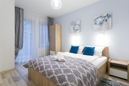 a bedroom with a bed with two towels on it at VIP Apartamenty Stara Polana in Zakopane