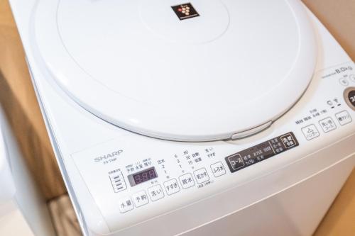 a close up of a washing machine at Muji Arashiyama Villa 無時嵐1階2階賃貸し 駅まで徒歩2分 in Kyoto