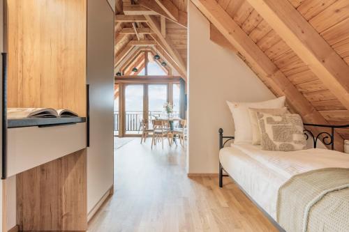 a bedroom with a bed and a dining room at Apres Ski Bachleda - LoftAffair Collection in Zakopane