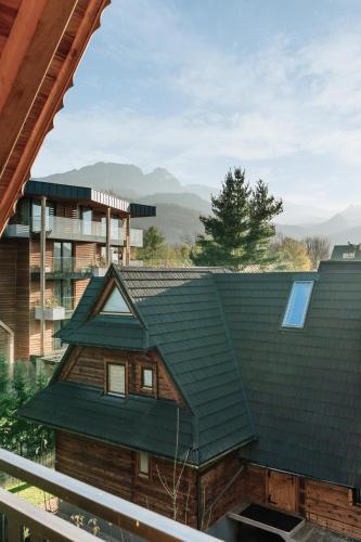 a house with a green roof at Apres Ski Bachleda - LoftAffair Collection in Zakopane