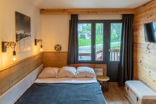 Postel nebo postele na pokoji v ubytování Courchevel au pied des pistes, La Tania