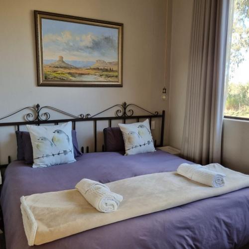 two beds sitting next to each other in a bedroom at The Fat Mulberry Guest Farm in Fouriesburg