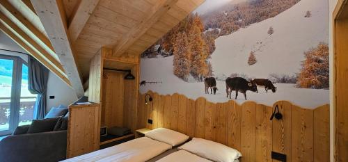 a bedroom with a mural of cows on the wall at Agriturismo Bosco d'oro Livigno in Livigno