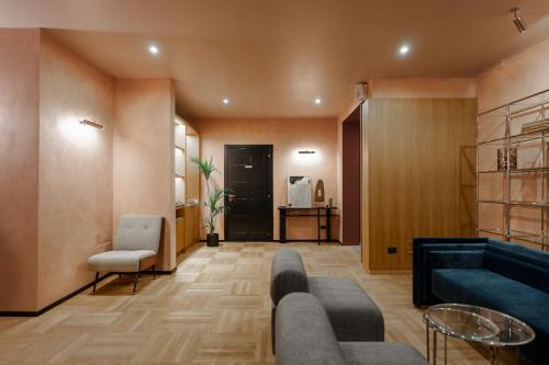 a living room with a couch and a chair at c-hotels Club in Florence