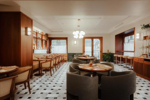 a dining room with wooden tables and chairs at c-hotels Club in Florence